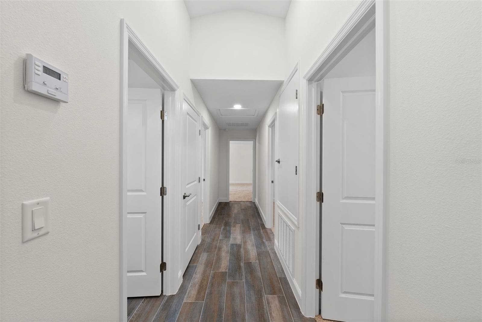 Hallway: Left Side - 2nd Full Bathroom, Laundry Closet, Bedroom 2; End of Hallway - Entrance to Primary Bedroom & Ensuite Bathroom; Ridht Side - Bedrooms 3 & 4 - 5062 80TH LN N, ST PETERSBURG