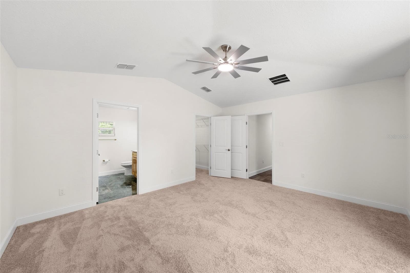 Primary Bedroom: Left Door - Ensuite Bathroom, Center - Walk-In Closet, Left Door - Hallway - 5062 80TH LN N, ST PETERSBURG
