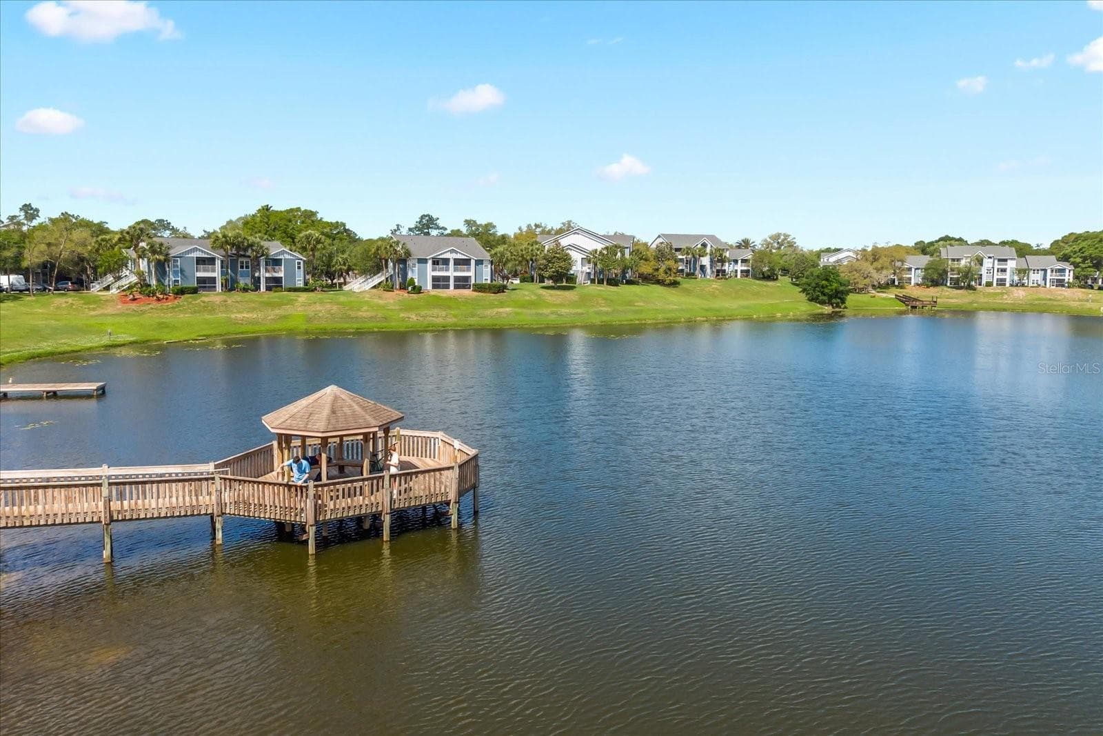 Building 35 with unit 103 is to the left in the background. Very close to community dock. - 2501 GRASSY POINT DR #103, LAKE MARY