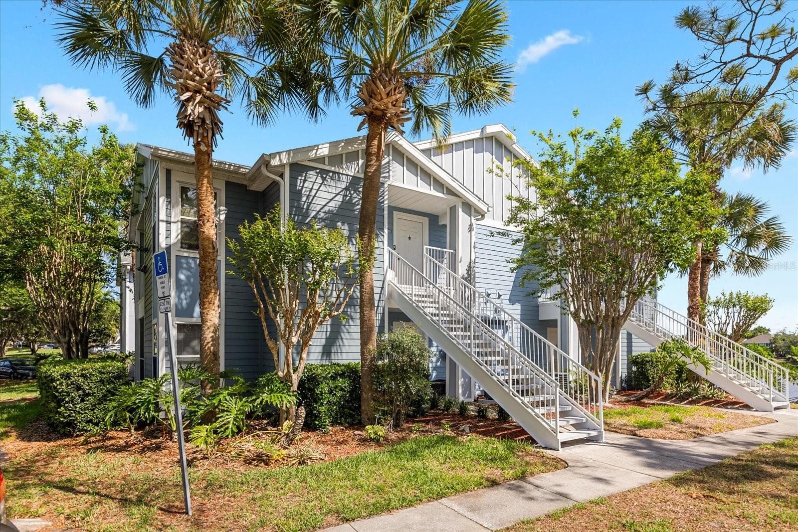 Walk way towards unit 103 on 1st floor. - 2501 GRASSY POINT DR #103, LAKE MARY