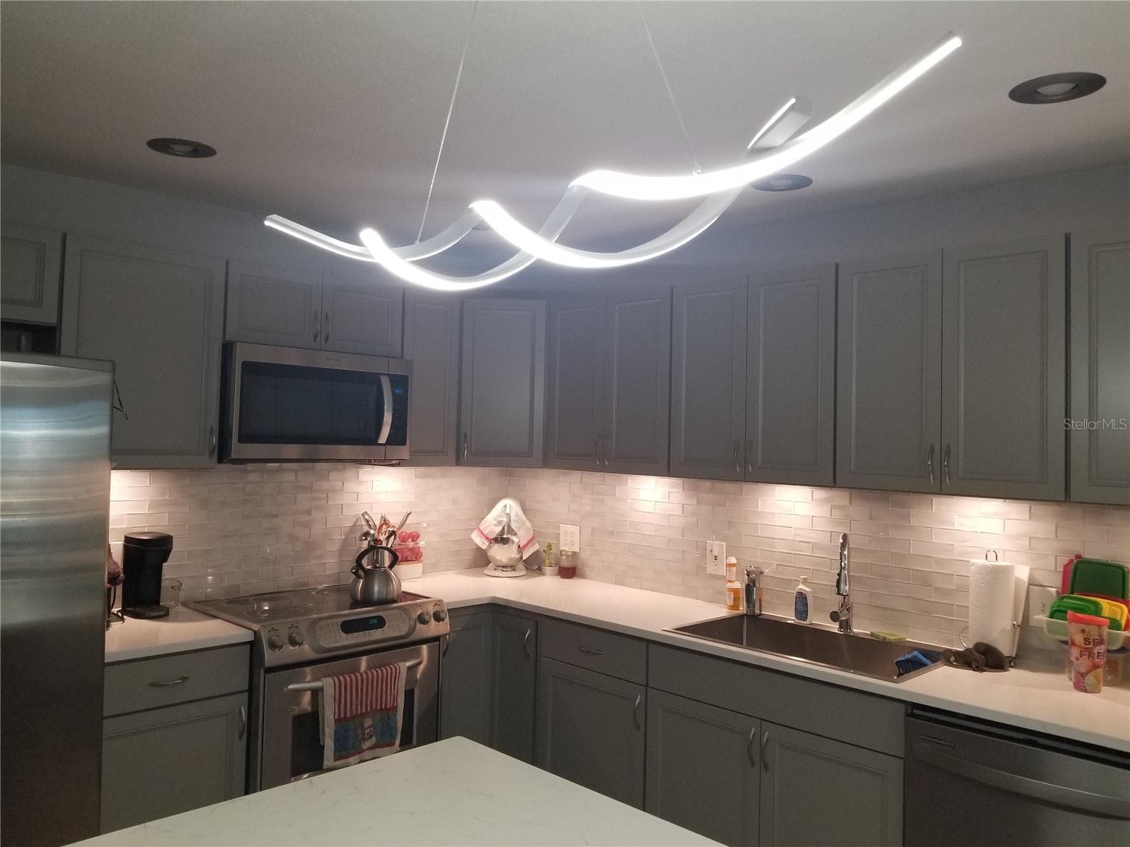 NEW OVER ISLAND LIGHTING MATCHES DINING AREA - 1720 FOSSIL DR, ENGLEWOOD