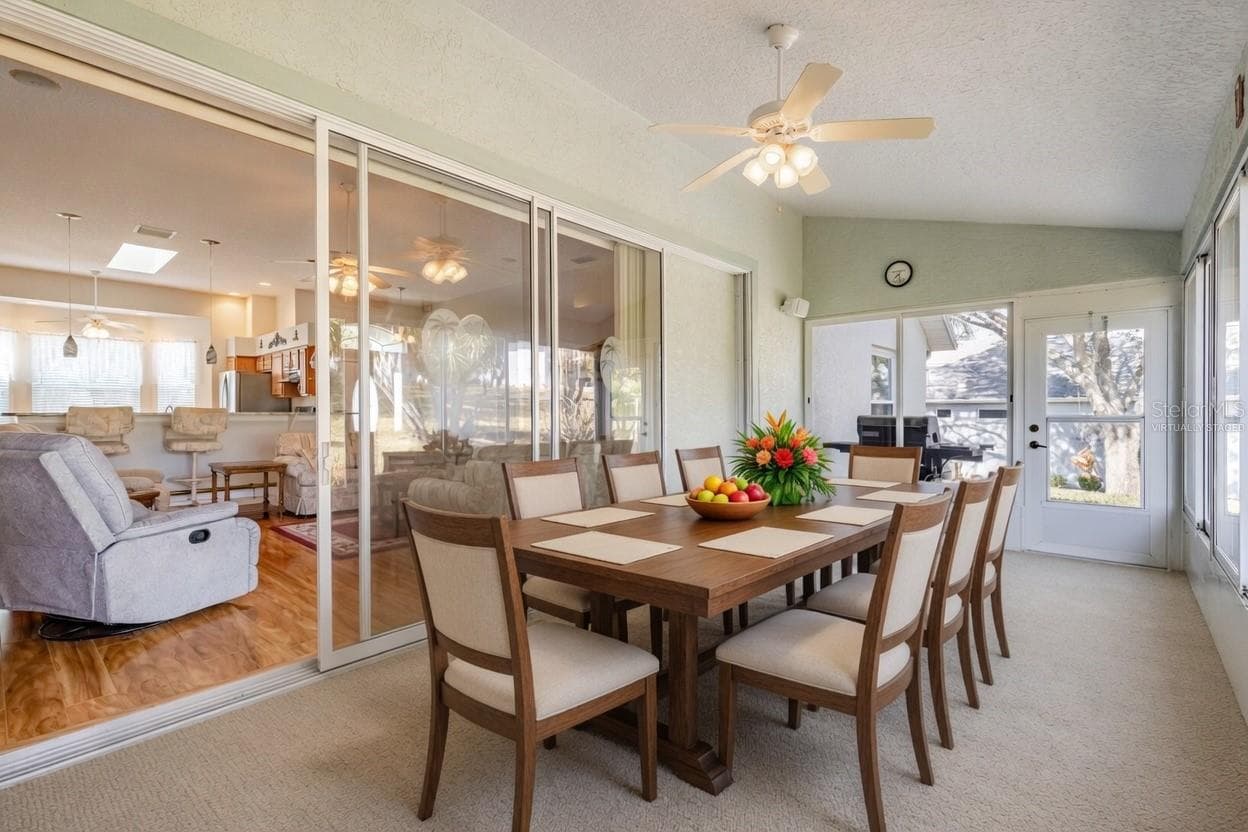 Florida Room virtually staged for family gatherings - 5732 FREEPORT DR, TAVARES