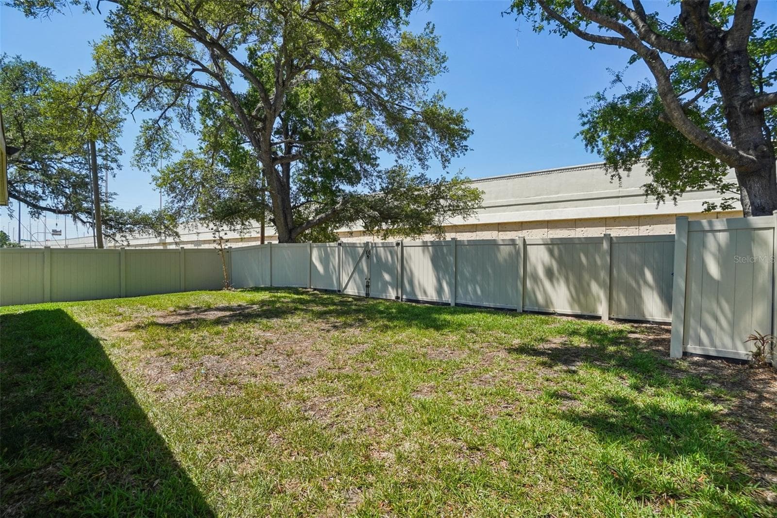 Large back yard comletely fenced with two entry gates in back which open to a former alleyway. - 3123 W LA SALLE ST, TAMPA