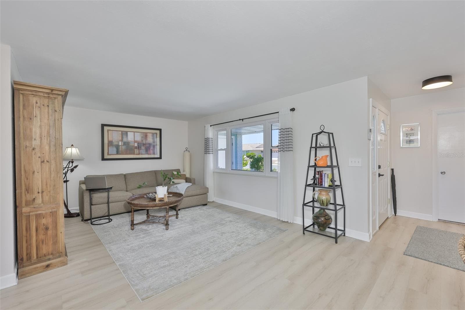 Front Living Room, Modern LVT Plank Flooring Throughout Main Living Area - 1704 DANBURY DR, SUN CITY CENTER