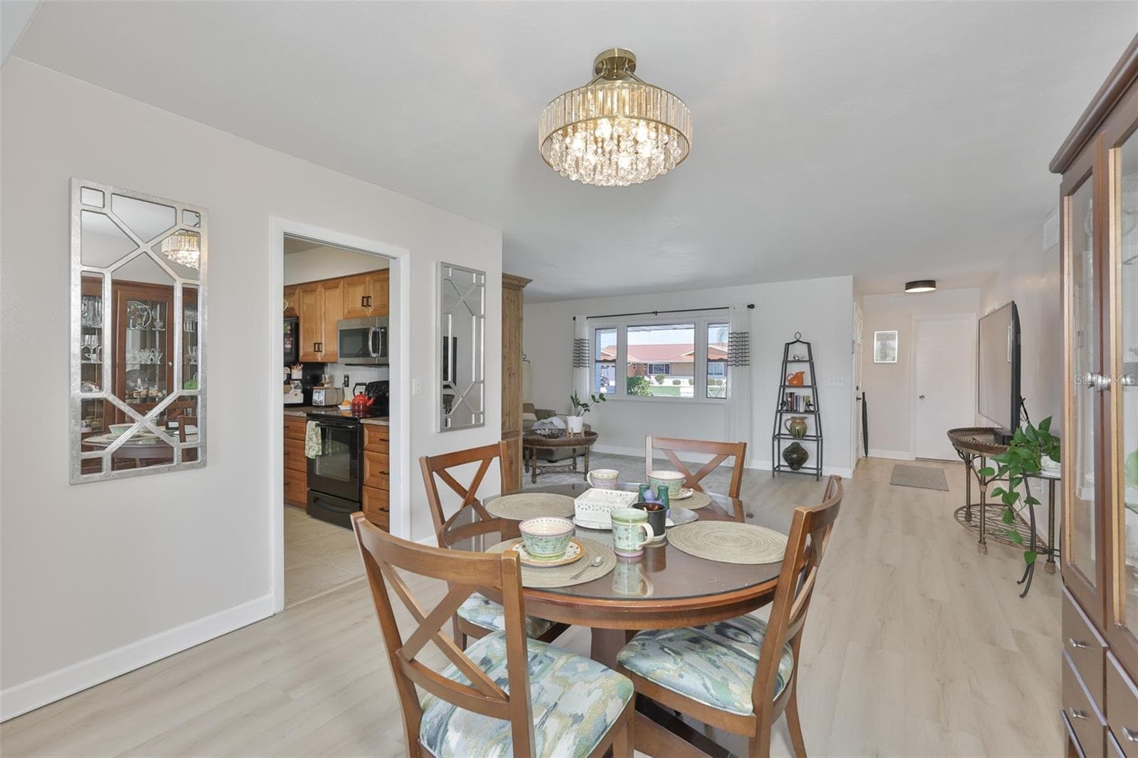 New LVT Plank Flooring Throughout Main Living Area, Updated Fans & Fixtures, Light & Bright Color Scheme, Fantastic South Lake Water View - 1704 DANBURY DR, SUN CITY CENTER