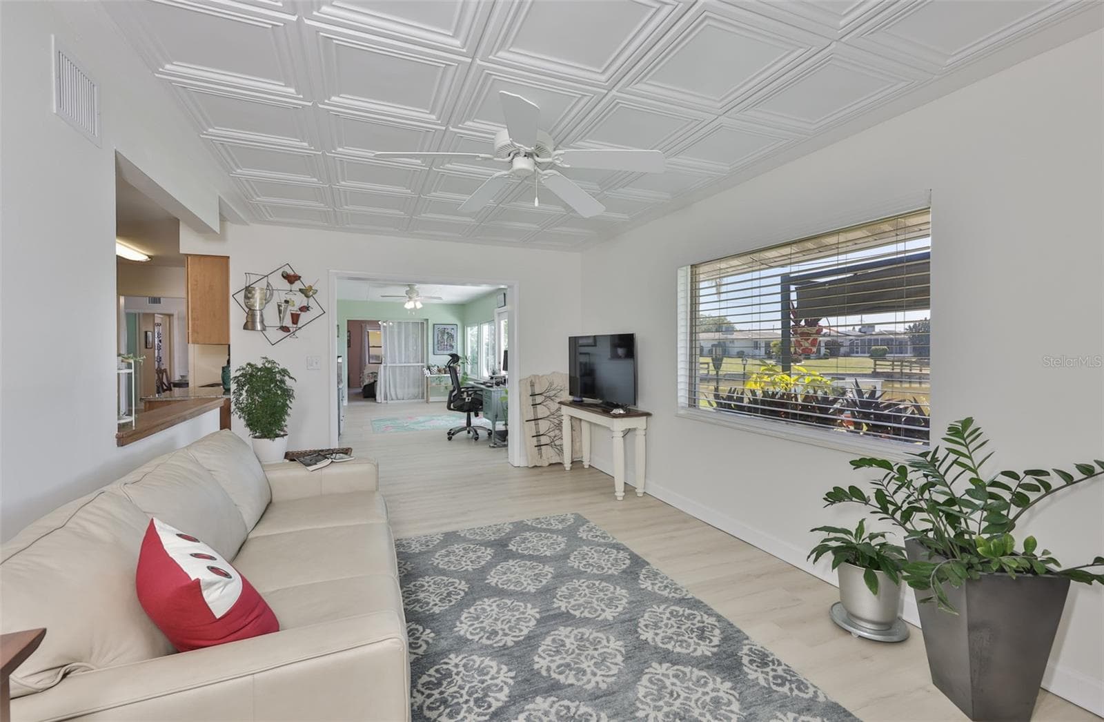 Great Room, Classic Elegant Coffered Ceiling & Electric Fireplace, Breathtaking Lake View, Plenty of Room for Entertaining Family & Friends - 1704 DANBURY DR, SUN CITY CENTER