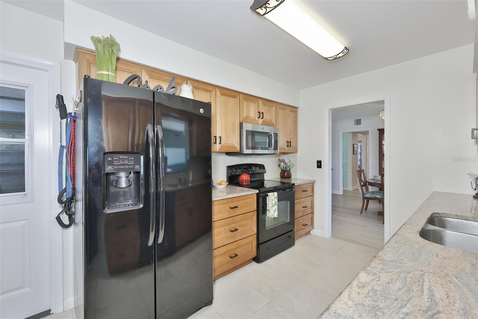 Galley Kitchen, Wood Cabinets & Granite Countertops & Closet Pantry - 1704 DANBURY DR, SUN CITY CENTER