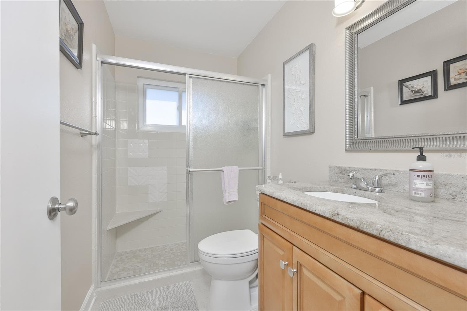 Guest Hall Bath, Wood High-Top Vanity & Exquisite Granite Countertop, Updated Mirror & Fixtures, Walk In Shower - 1704 DANBURY DR, SUN CITY CENTER