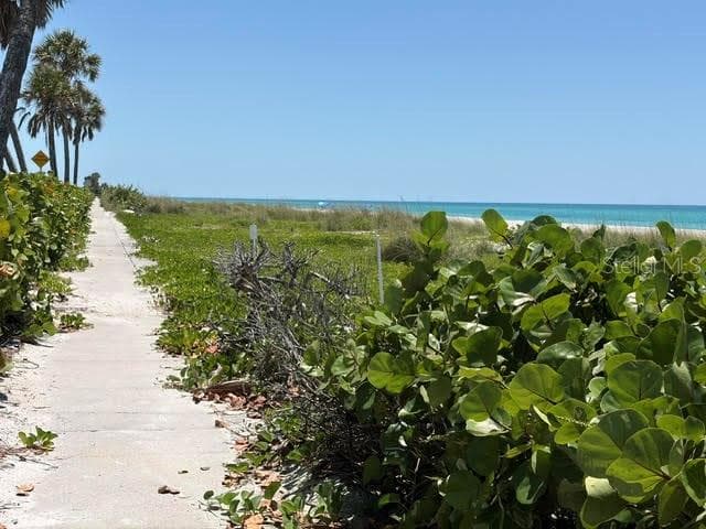 As you enter the beach access, there is a paved concrete sidewalk that runs along the beach, perfect for bikes, baby carriages, and little wagons! - 581 ROUNTREE DR, LONGBOAT KEY