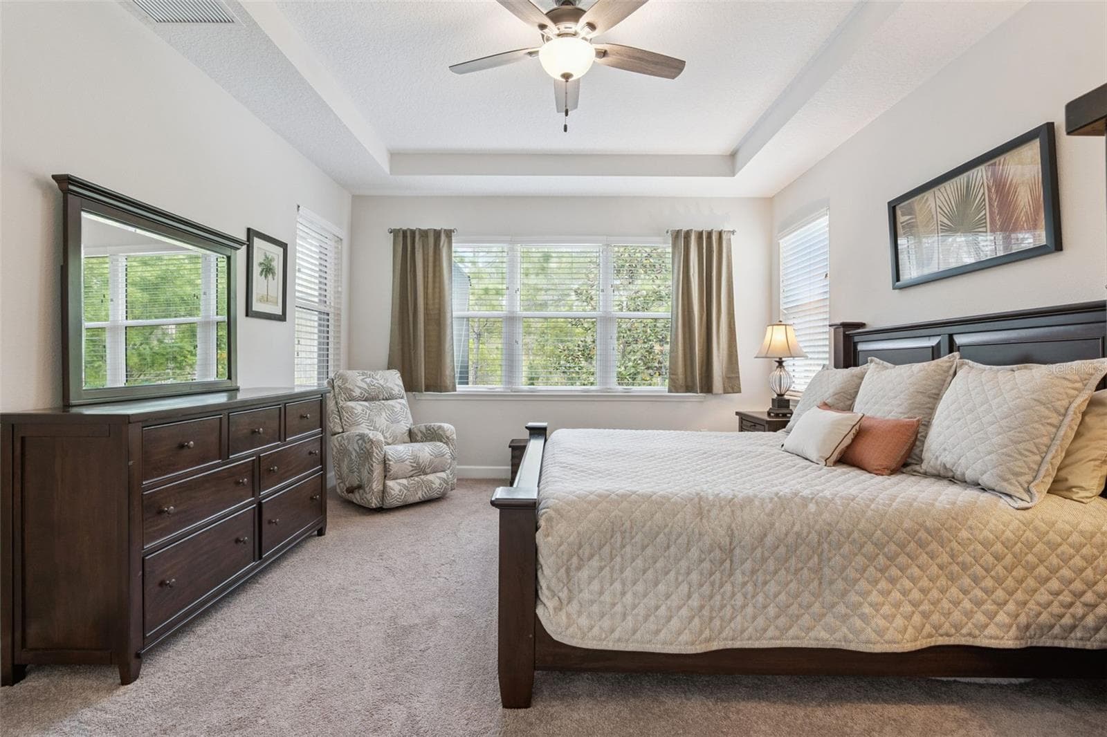 Primary bedroom with large windows overlooking private wooded view - 1157 AVERY MEADOWS WAY, DELAND