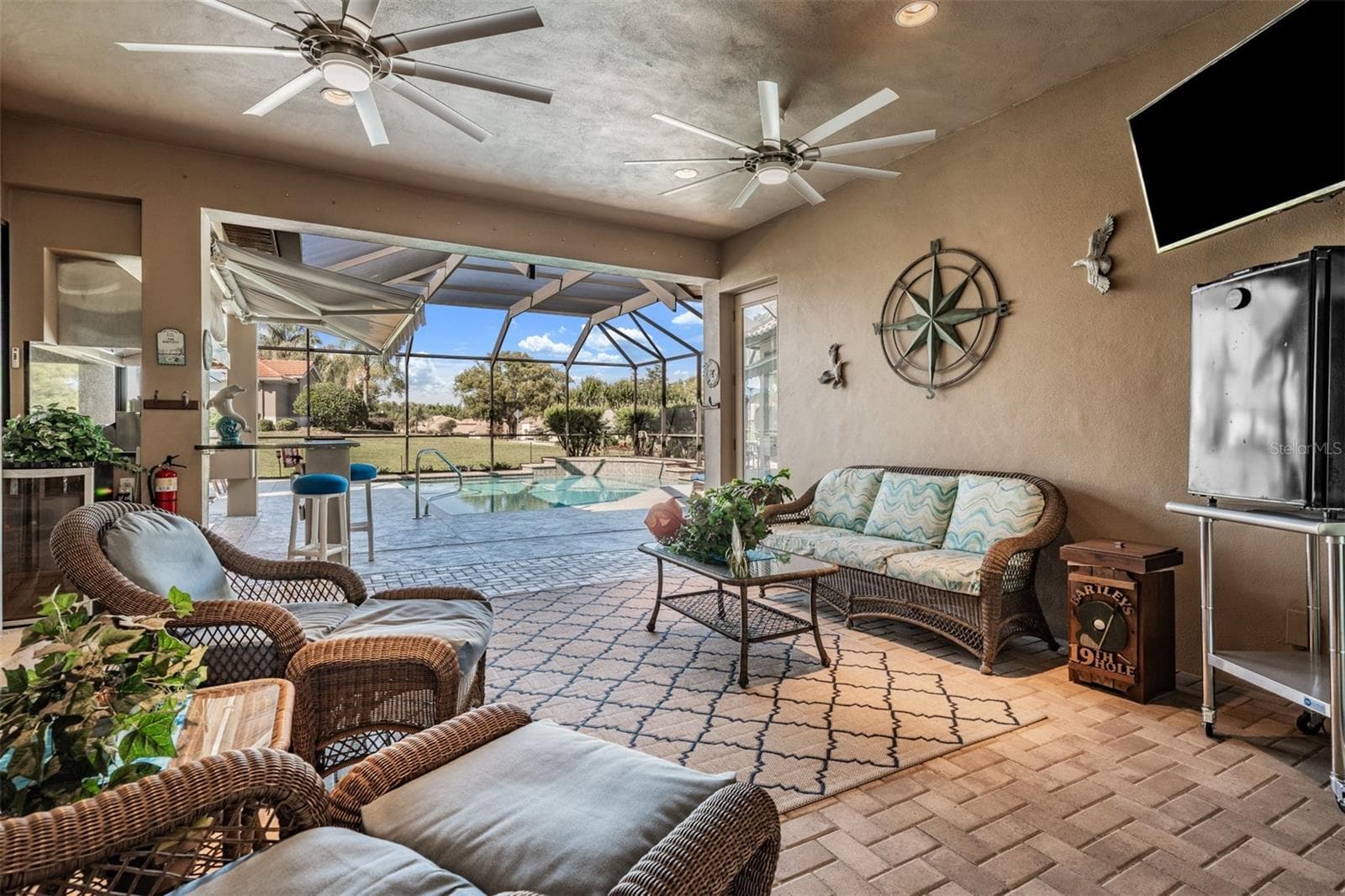 Covered lanai overlooks pool - 34115 AMERICANA AVE, DADE CITY