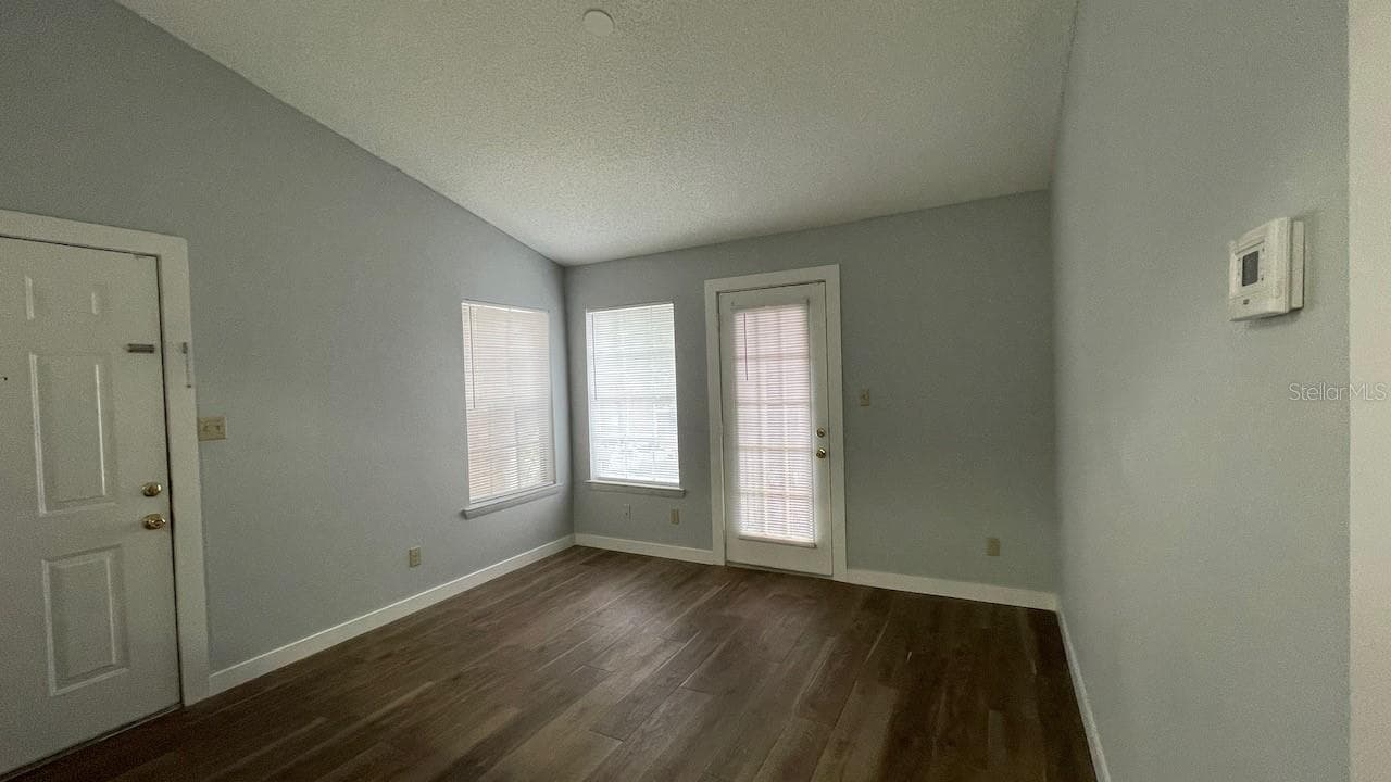Living room with french door leading to balcony - 4225 THORNBRIAR LN #201, ORLANDO