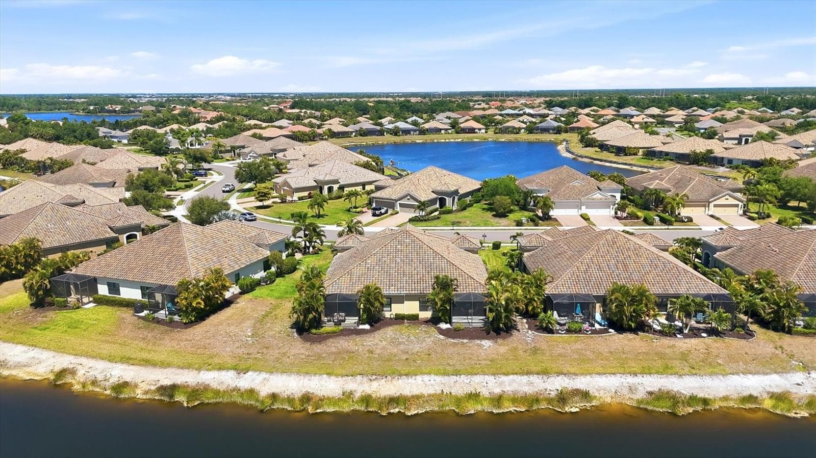 Aerial views overlooking lake - 1359 BACKSPIN DR, ENGLEWOOD