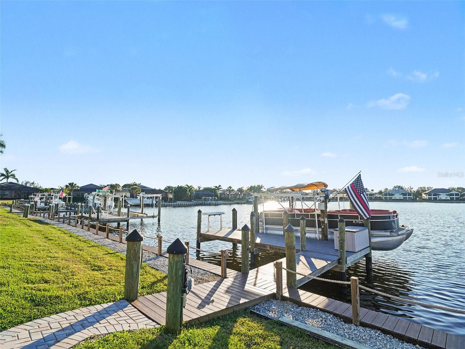 Private dock and boat lift overlooking wide water views, offering convenient boating access and a true waterfront living experience. - 1018 OVERLOOK CT, BRADENTON