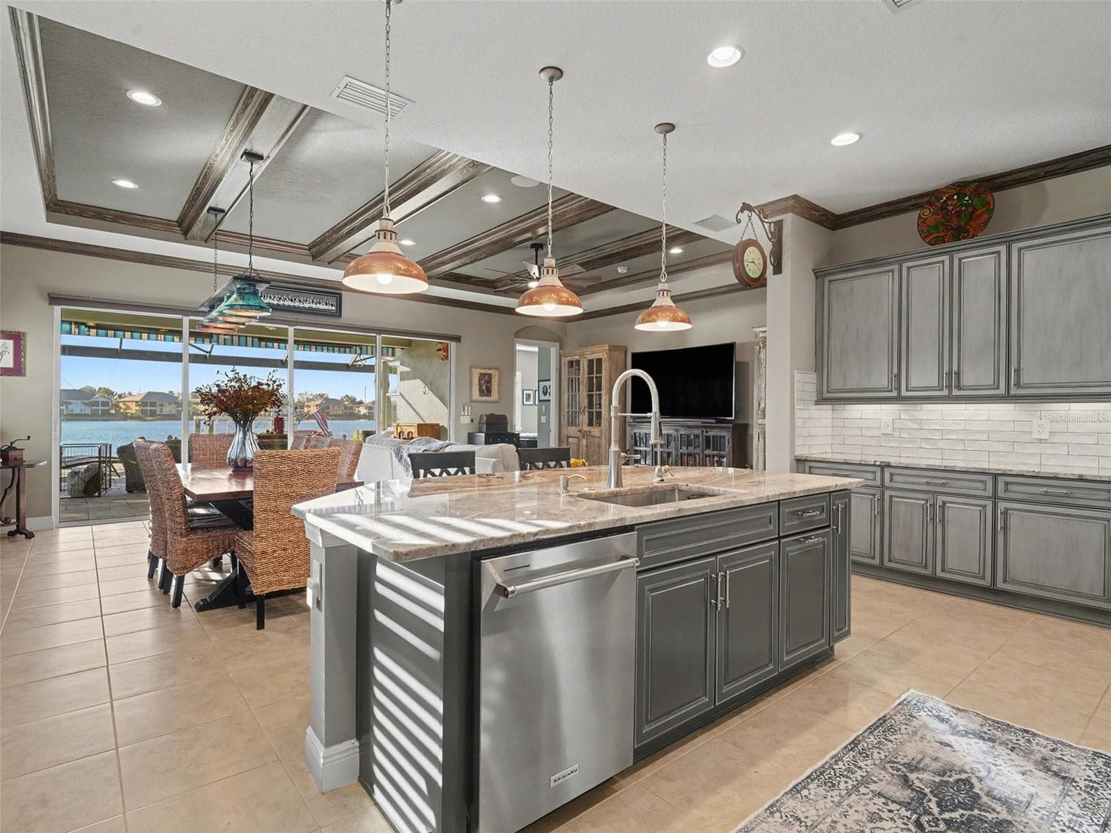 Spacious chef’s kitchen featuring a large center island, custom cabinetry, and an open layout designed for everyday living and entertaining. - 1018 OVERLOOK CT, BRADENTON