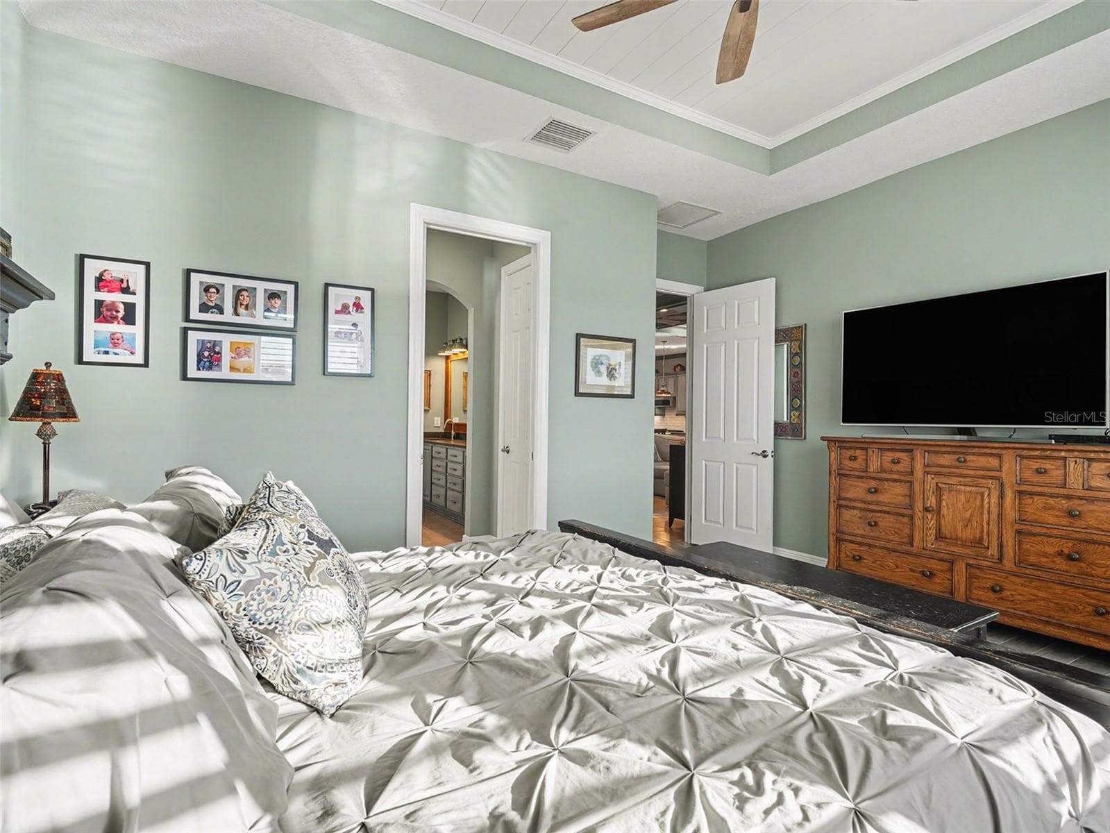 Luxurious primary bedroom with tray ceiling detail, generous natural light, and a peaceful retreat feel. - 1018 OVERLOOK CT, BRADENTON