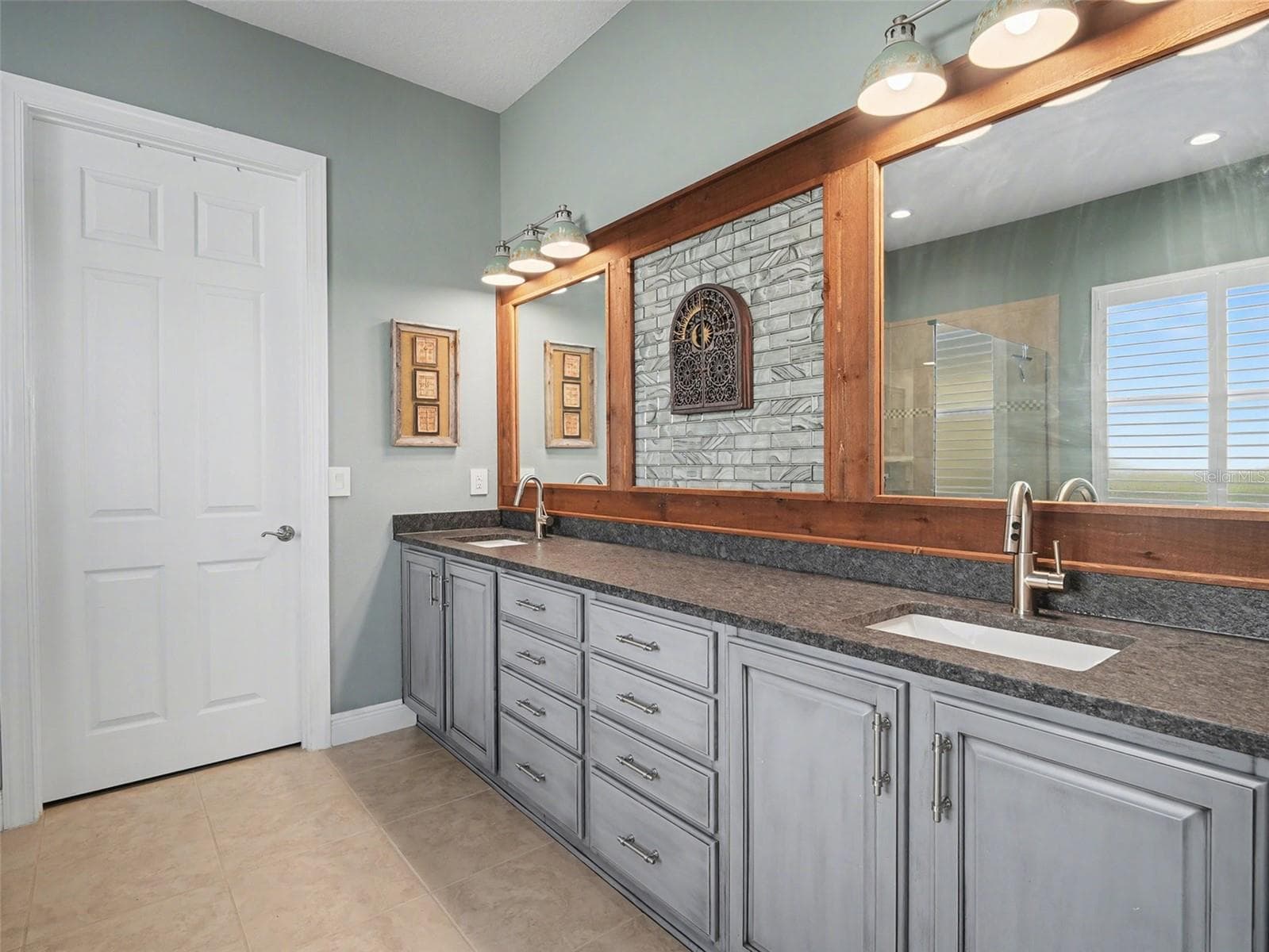 Luxurious primary bedroom with tray ceiling detail, generous natural light, and a peaceful retreat feel. - 1018 OVERLOOK CT, BRADENTON