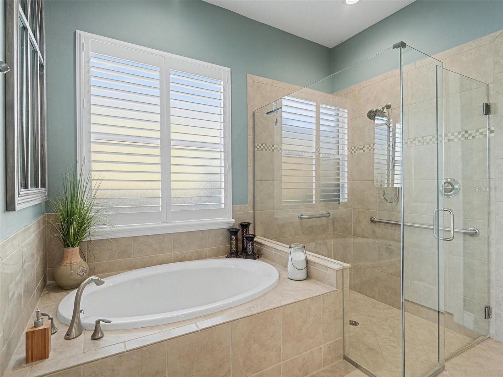 Spa inspired primary bathroom with soaking tub, walk in shower, and a bright, relaxing atmosphere. - 1018 OVERLOOK CT, BRADENTON