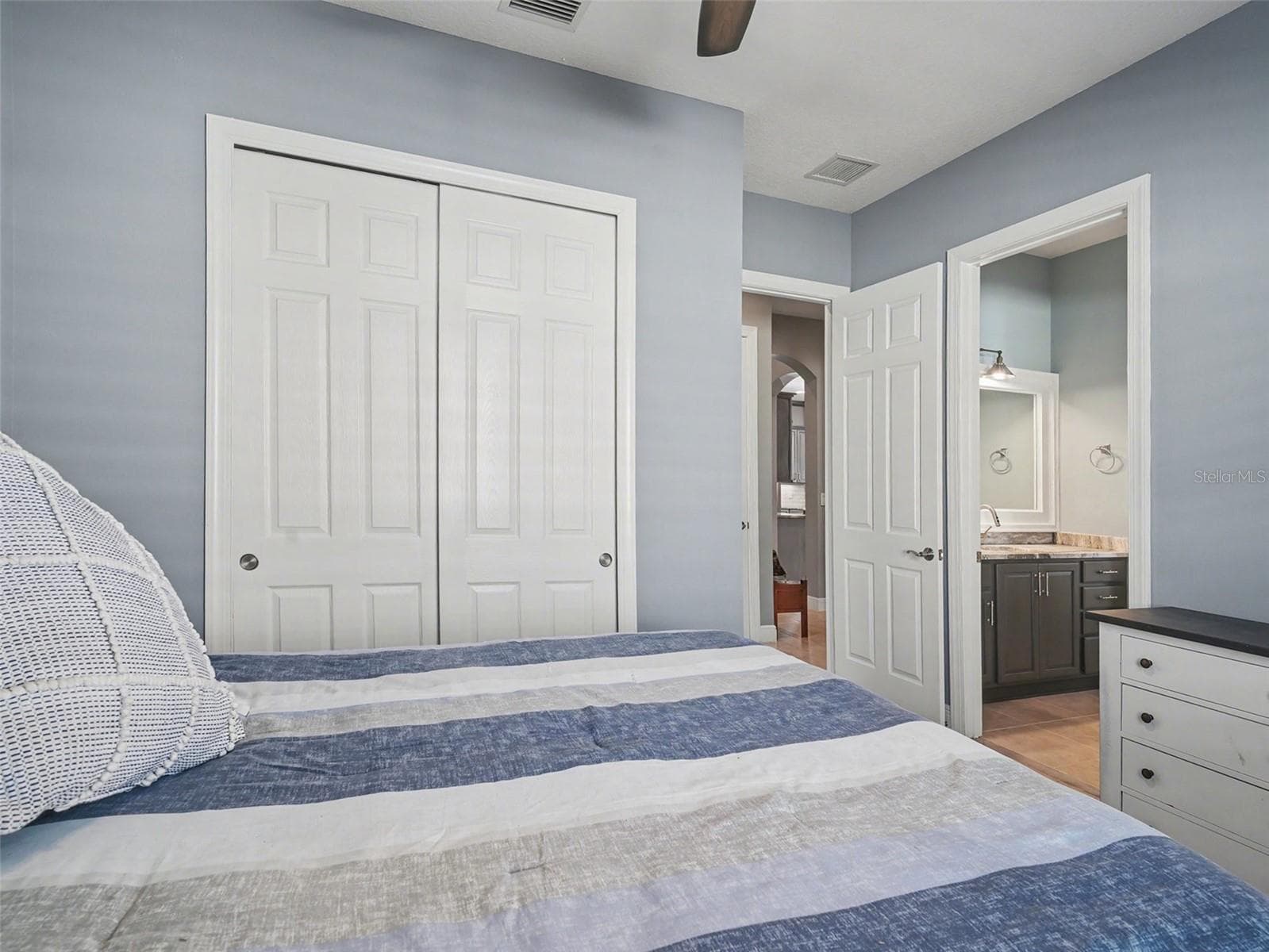 Guest bedroom with spacious closet, neutral finishes, and an airy design that feels both functional and inviting. - 1018 OVERLOOK CT, BRADENTON