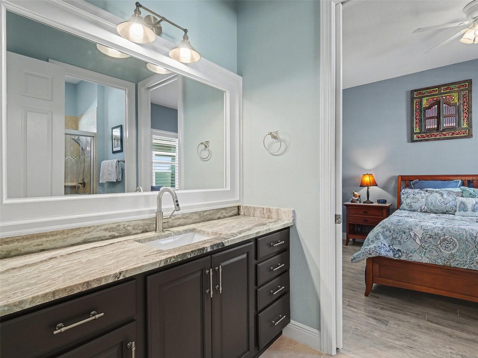 Well designed guest bathroom vanity with ample counter space, stylish finishes, and convenient access to the adjacent bedroom. - 1018 OVERLOOK CT, BRADENTON