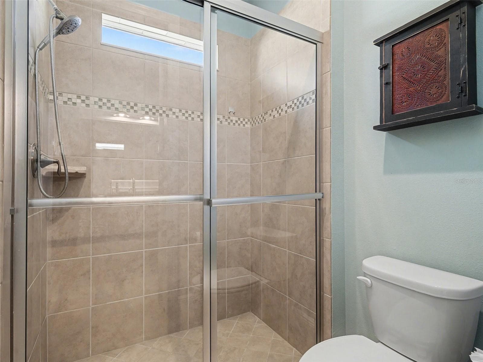 Guest bathroom with walk in shower and clean, modern finishes designed for comfort and convenience. - 1018 OVERLOOK CT, BRADENTON