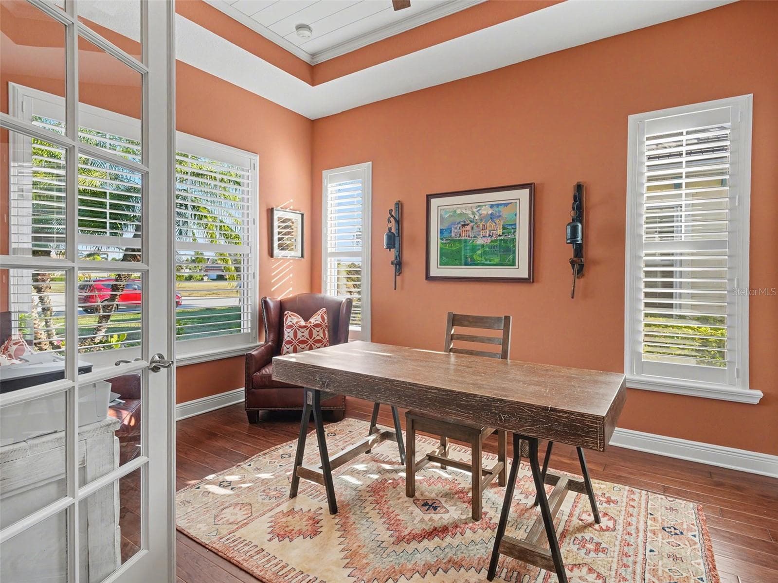 Bright home office with large windows, abundant natural light, and a comfortable layout ideal for working from home. - 1018 OVERLOOK CT, BRADENTON