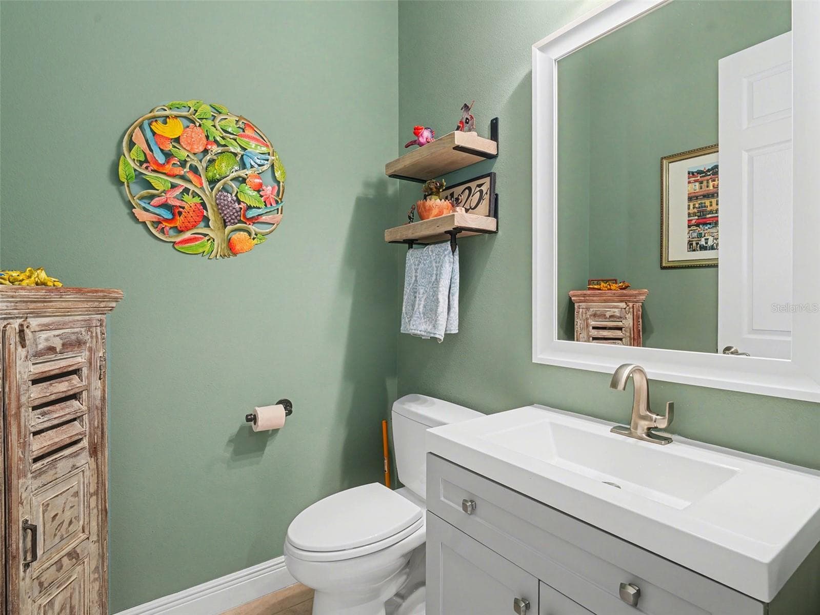 Charming powder room with decorative accents and a fresh, inviting design. - 1018 OVERLOOK CT, BRADENTON