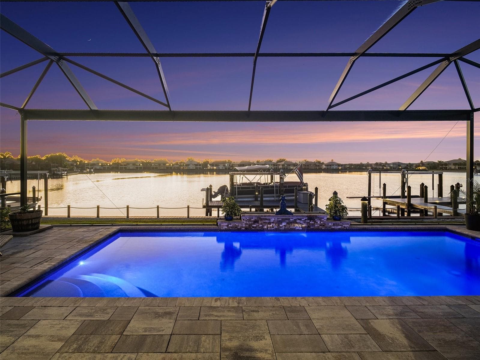 Evening pool and spa view with dramatic lighting, tranquil water, and a luxurious atmosphere for outdoor living. - 1018 OVERLOOK CT, BRADENTON