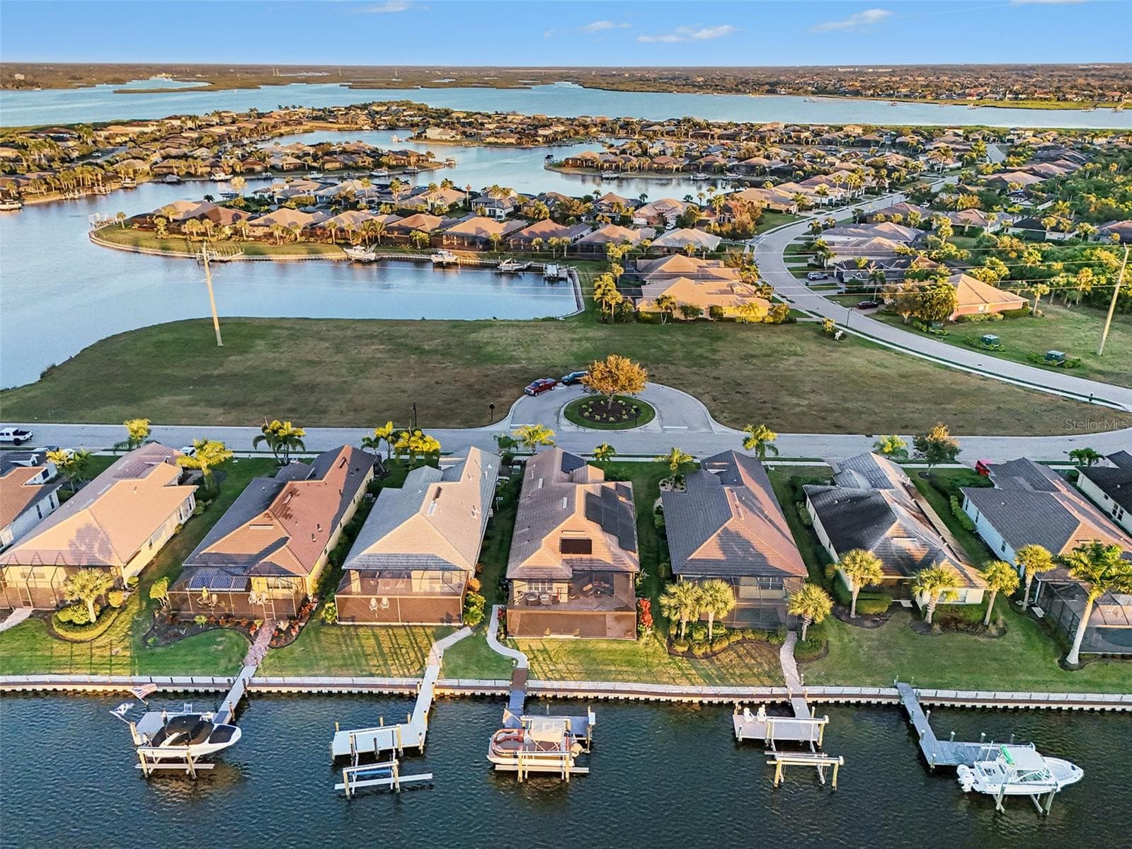 Aerial view of the waterfront property showcasing private dockage, surrounding waterways, and the neighborhood setting. - 1018 OVERLOOK CT, BRADENTON