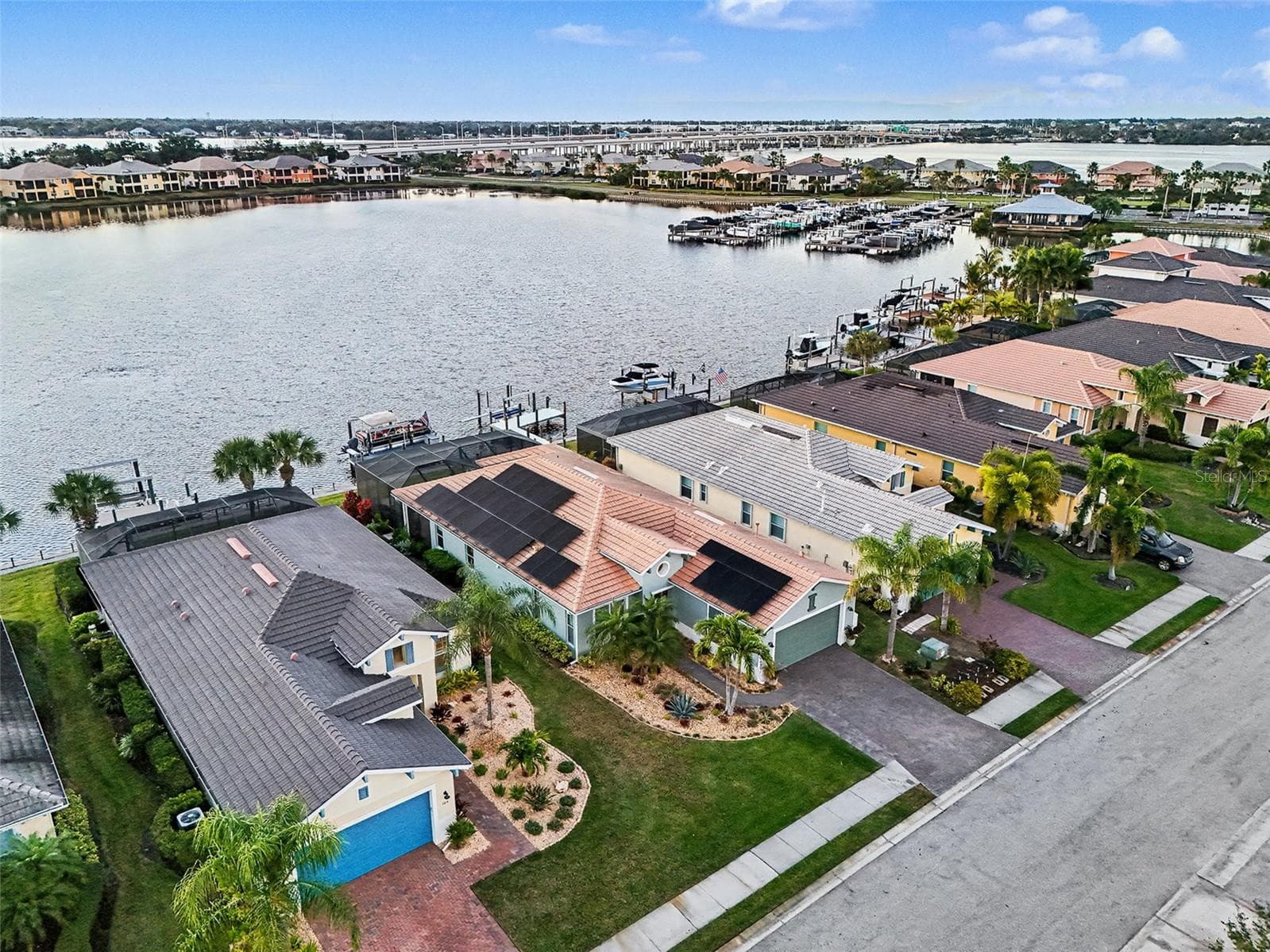 Bird’s eye view of the home and waterfront lot with dock, seawall, and direct access to open water. - 1018 OVERLOOK CT, BRADENTON