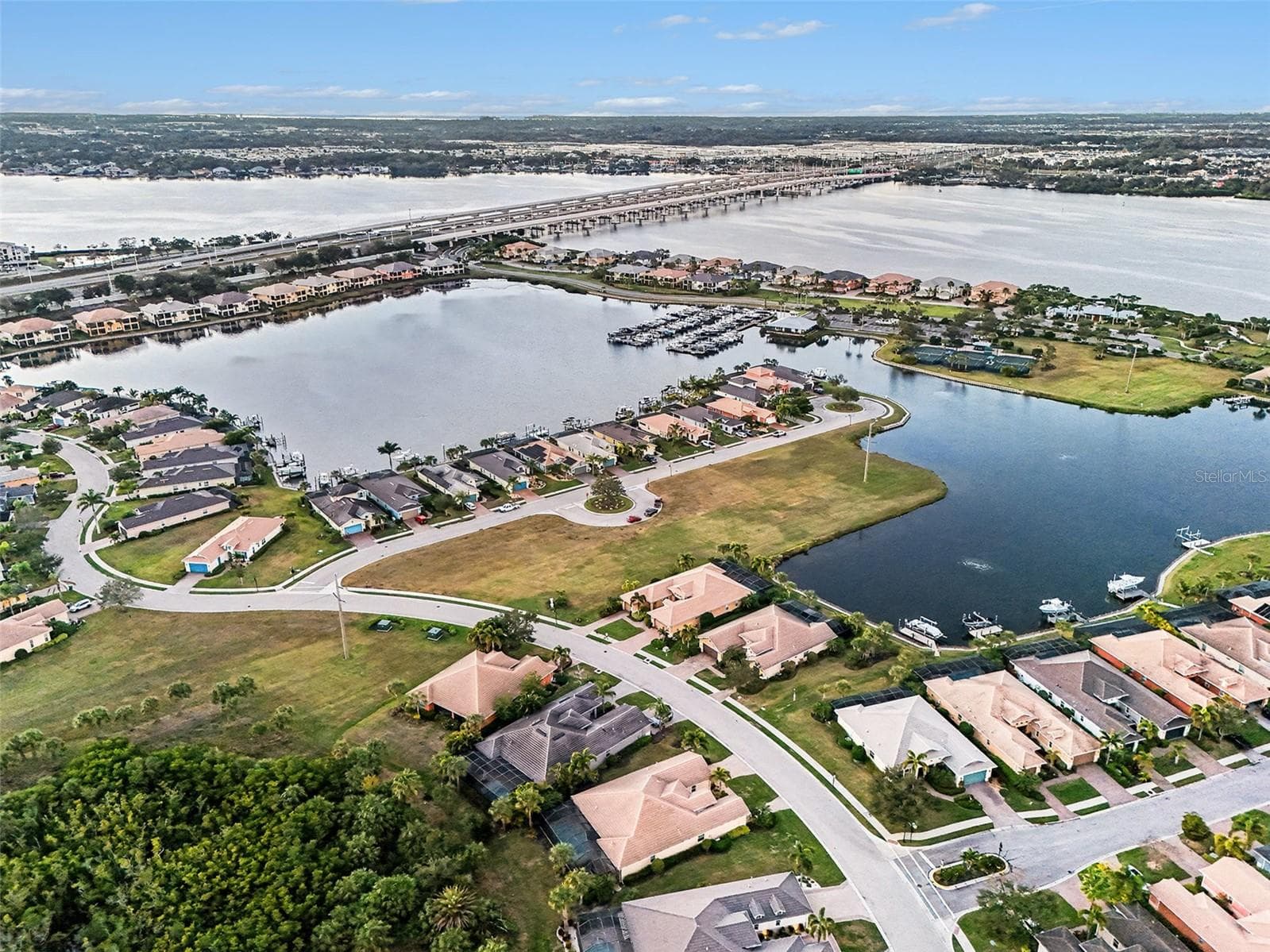 Aerial neighborhood view highlighting the home’s proximity to water, community features, and the surrounding coastal environment. - 1018 OVERLOOK CT, BRADENTON