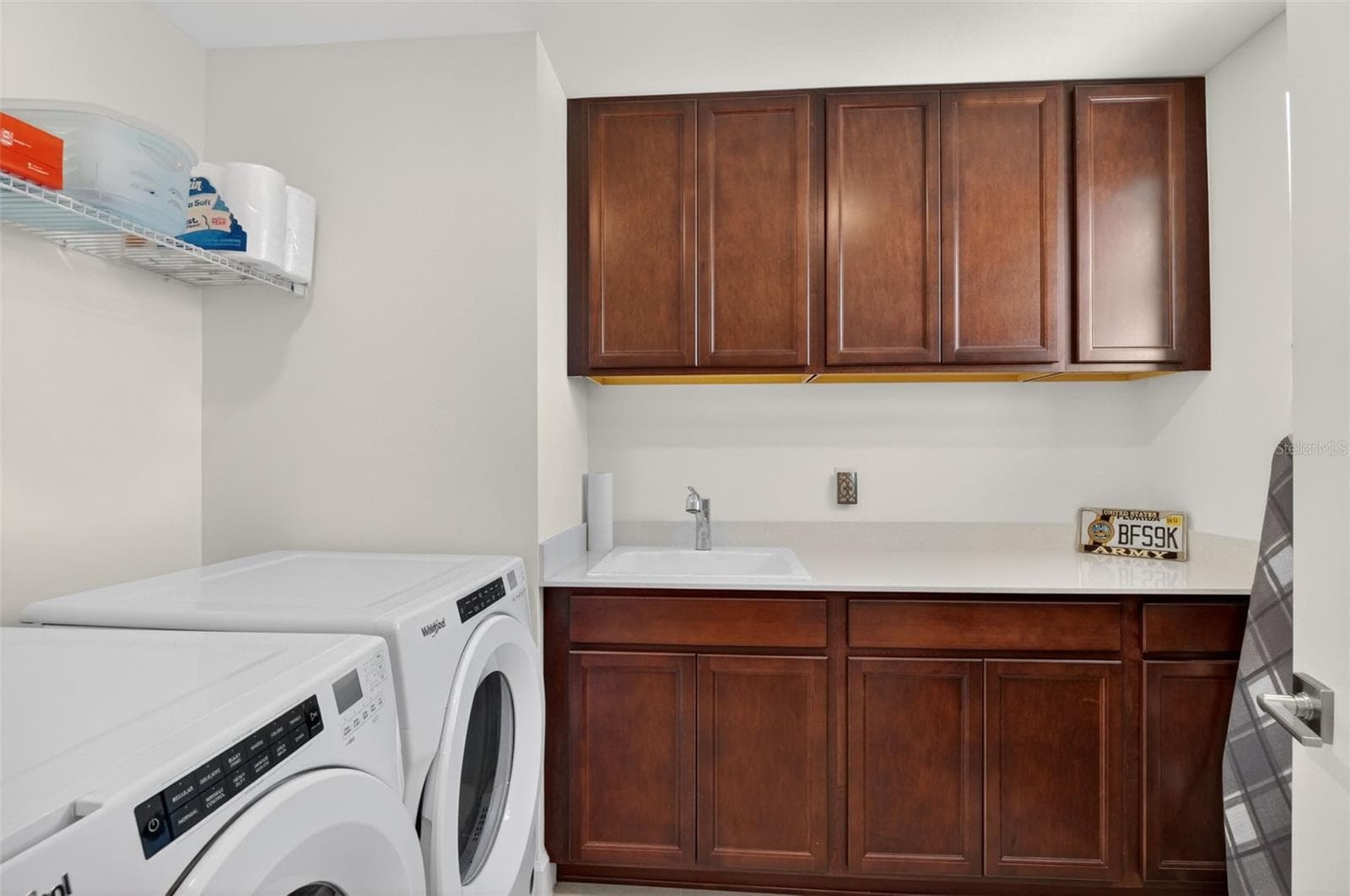 Laundry area with upgraded built in cabinets and laundry sink - 42581 ATLAS DR, PUNTA GORDA