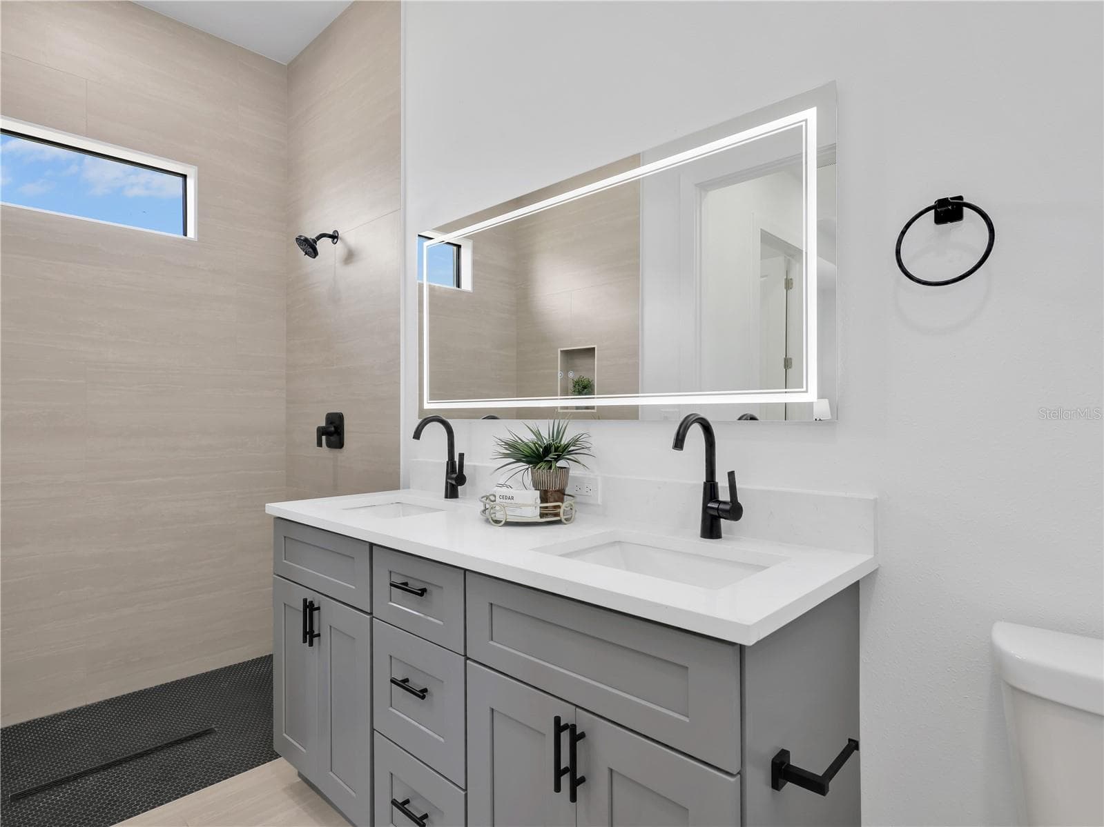 Dual vanity with white countertop and gray cabinetry photos used from another listing to show what it would look like with furniture - 1310 NW 11TH TER, CAPE CORAL