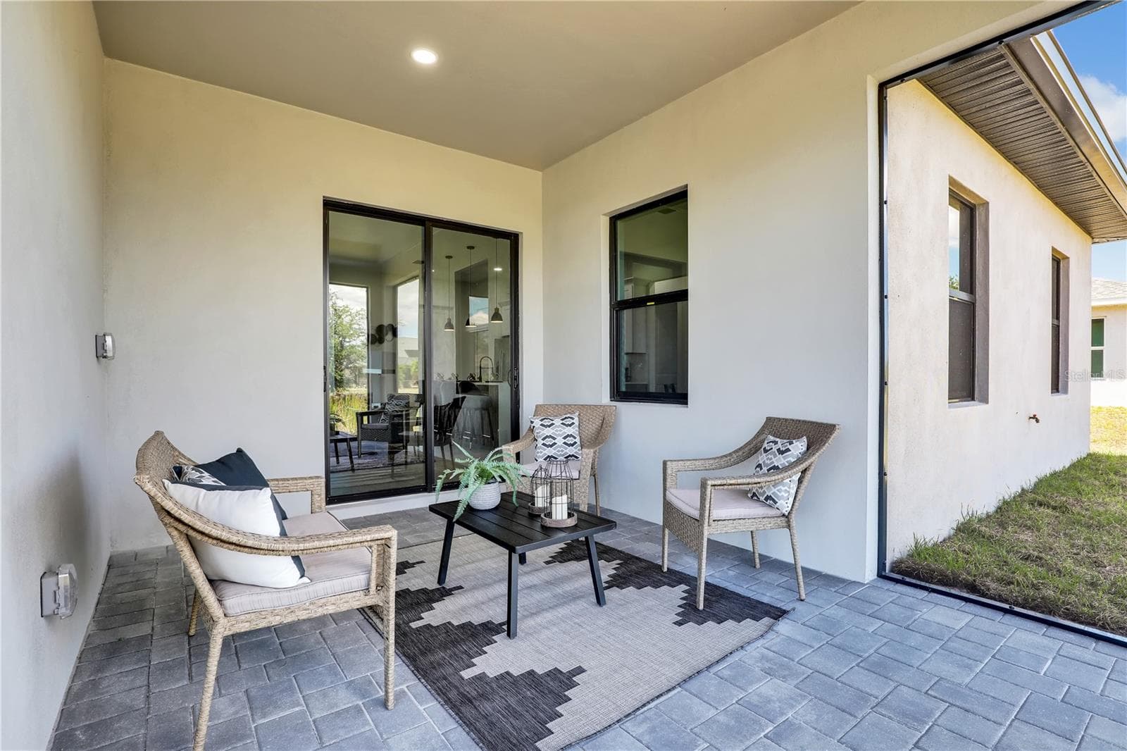 Covered patio featuring paver flooring, ecessed lighting, and a sliding glass door photos used from another listing to show what it would look like with furniture - 1310 NW 11TH TER, CAPE CORAL