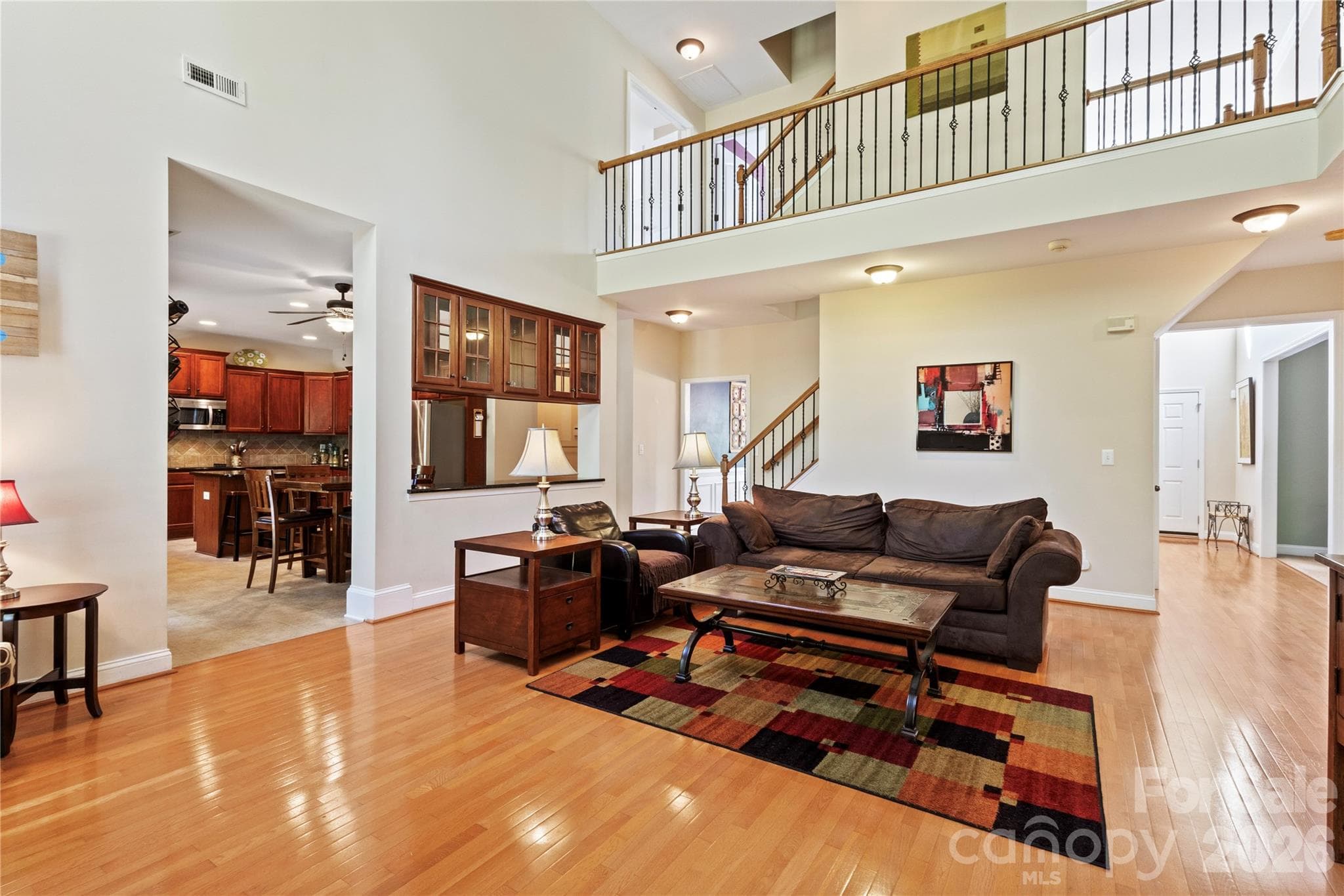Another view of the Two Story Great Room looking into the Kitchen and Upstairs. - 8458 Mossy Cup Trail, Harrisburg