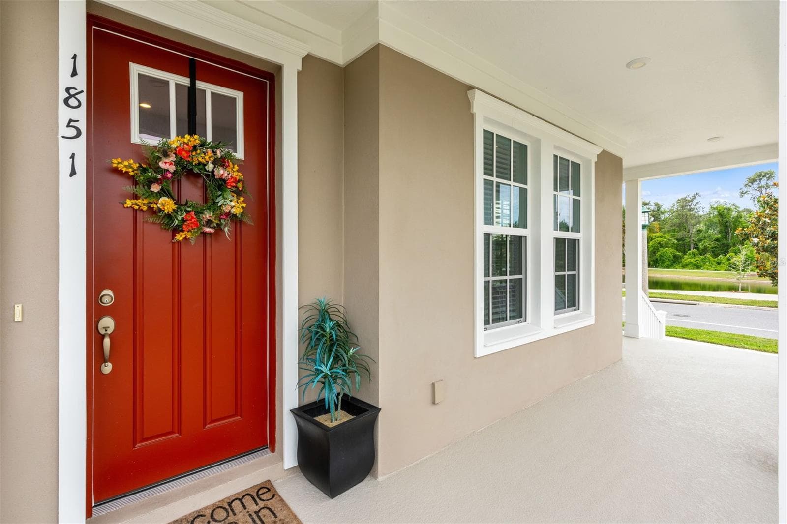 Beginning of wrap arond porch with water views - 1851 COASTAL CT, CELEBRATION