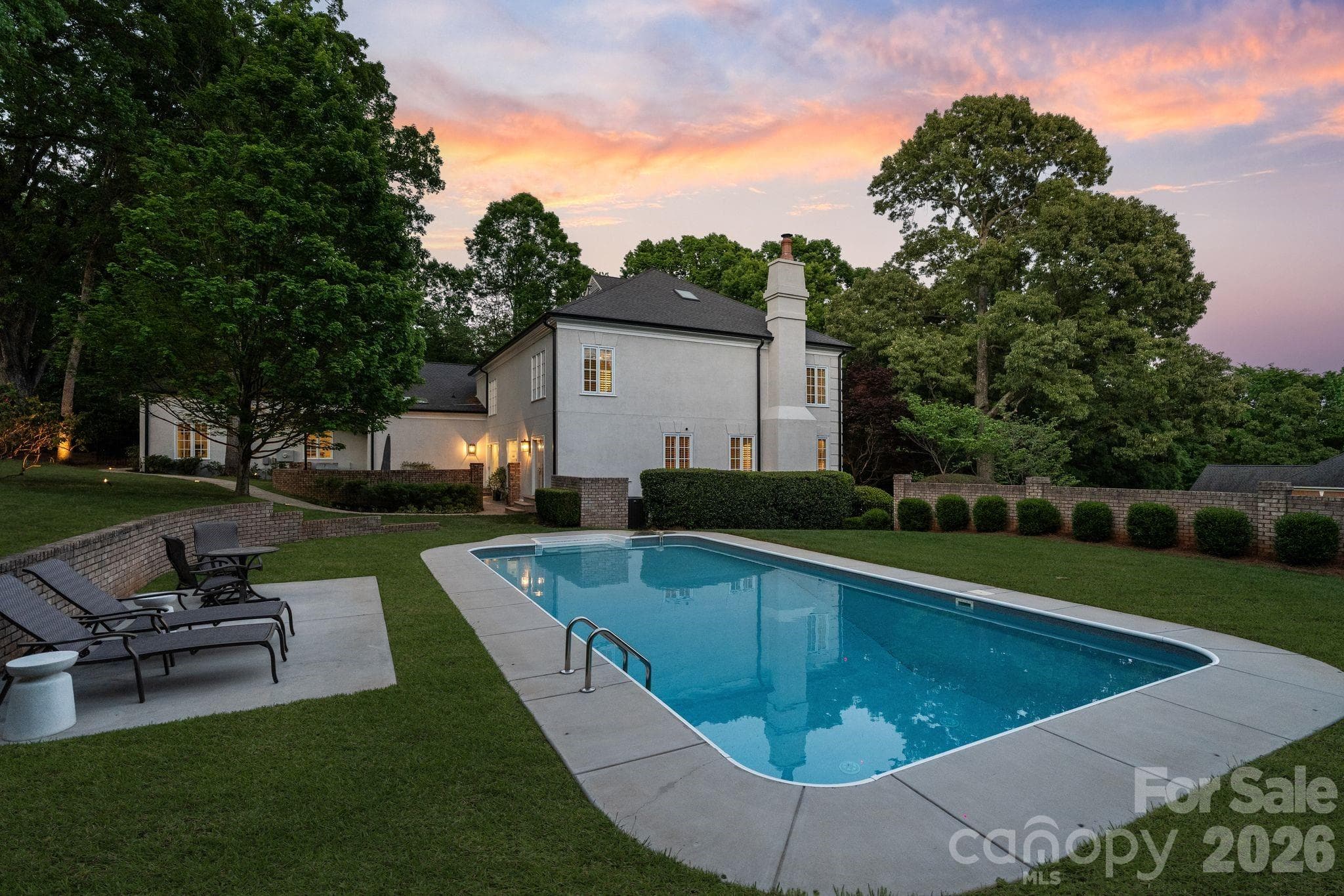 Backyard pool and lounge area at twilight. - Quail Hollow, Charlotte