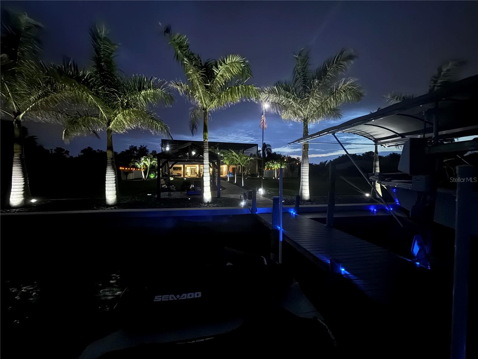 Composite Dock Features a Covered Boat Lift, Dual Jet Skit Lift, and Direct Access to Open Water. - 2424 HARBOUR DR, PUNTA GORDA