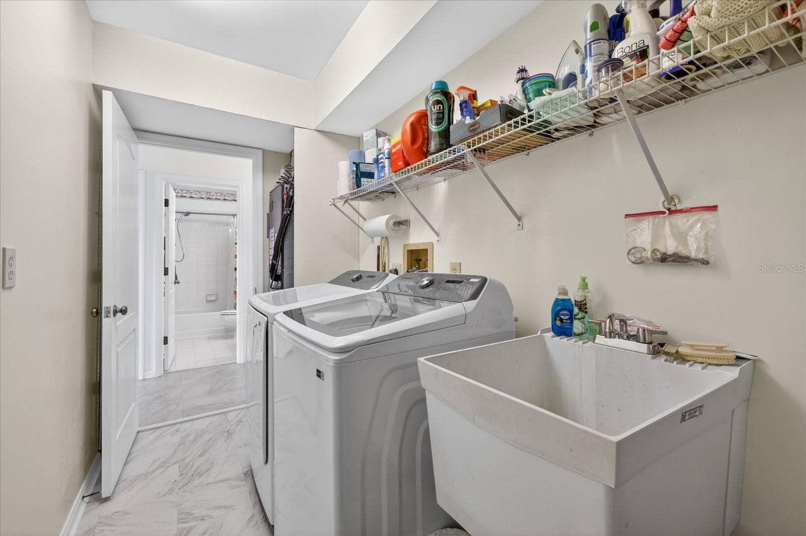 Laundry room with sink W/D and laudry chute from primary closet behind door. - 4340 SEAGULL DR, NEW PORT RICHEY