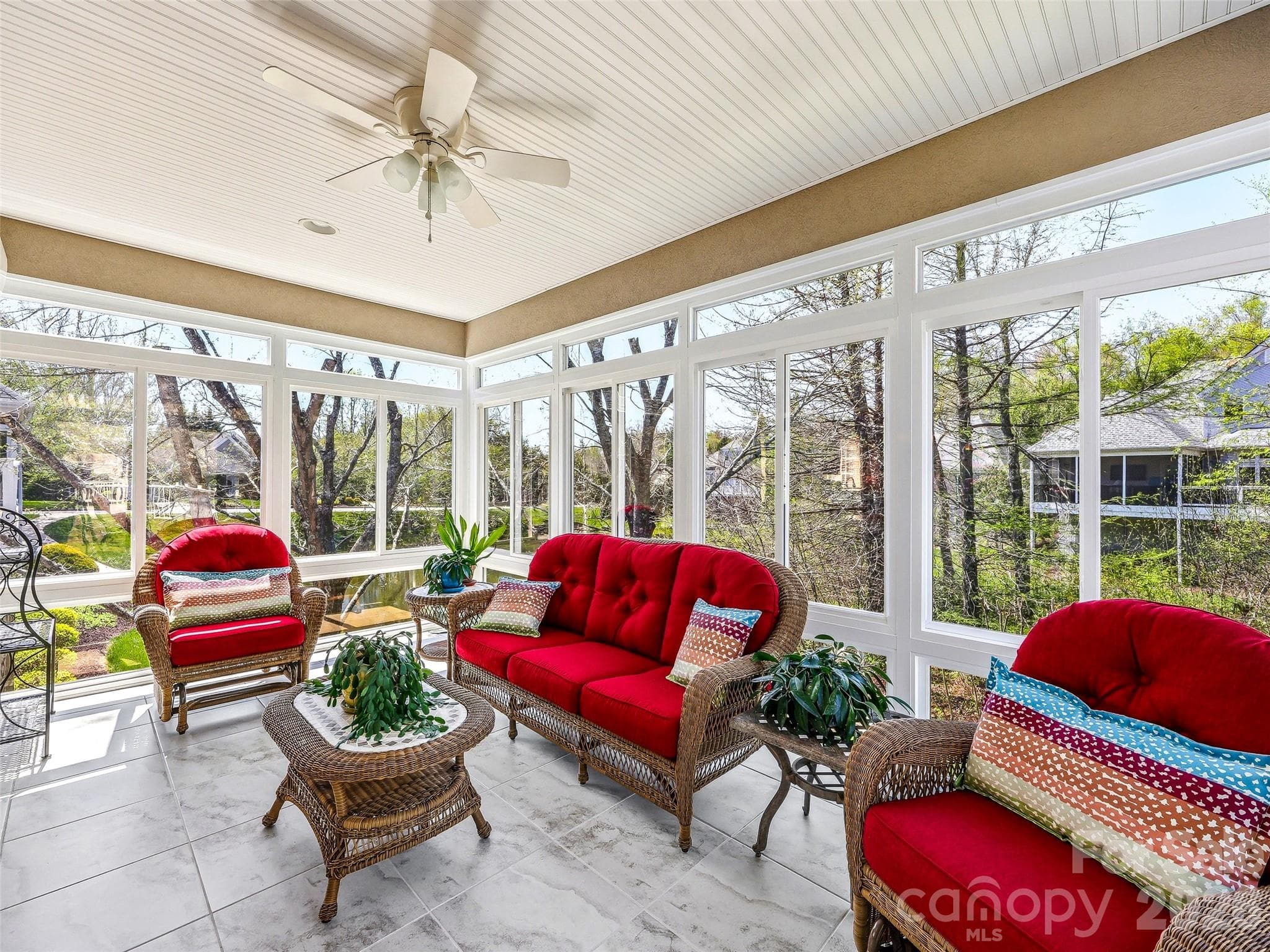 The heated and cooled all-season porch overlooks the lovely pond and manicured lawn, and offers striking westerly sunset views. - 33 Tiverton Lane, Asheville