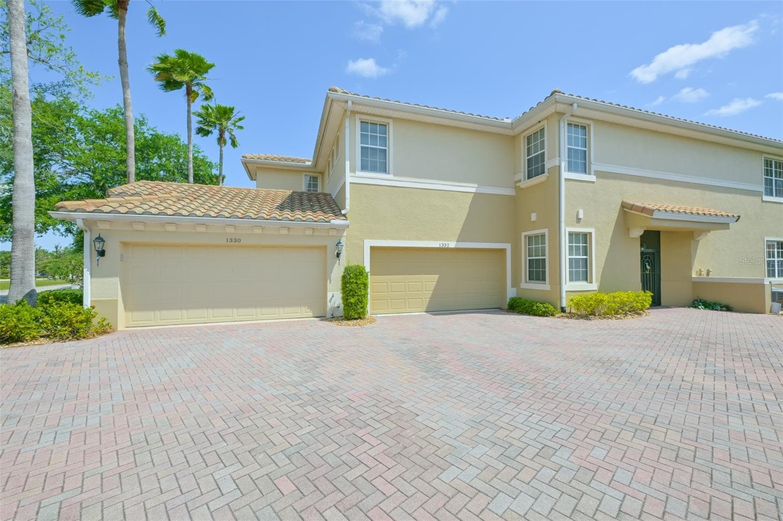 Two car garage spacious paver driveway. - 1330 EMERALD DUNES DR, SUN CITY CENTER