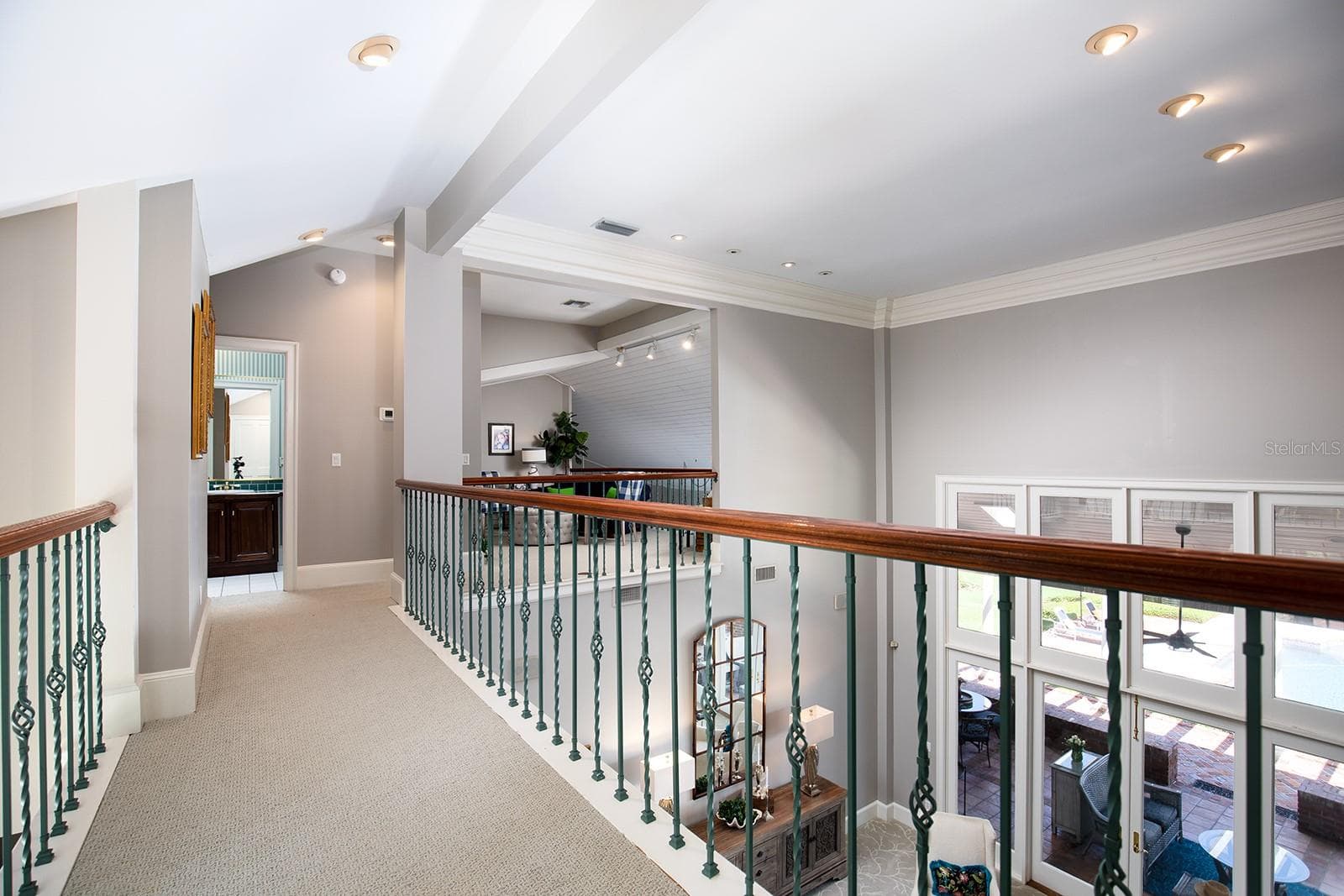 Walkway above the first floor that leads to the loft, additional bedroom and bathroom. Private get away space and yet you still feel like you are part of the main activities. - 1351 N CLASSIC CT, LONGWOOD