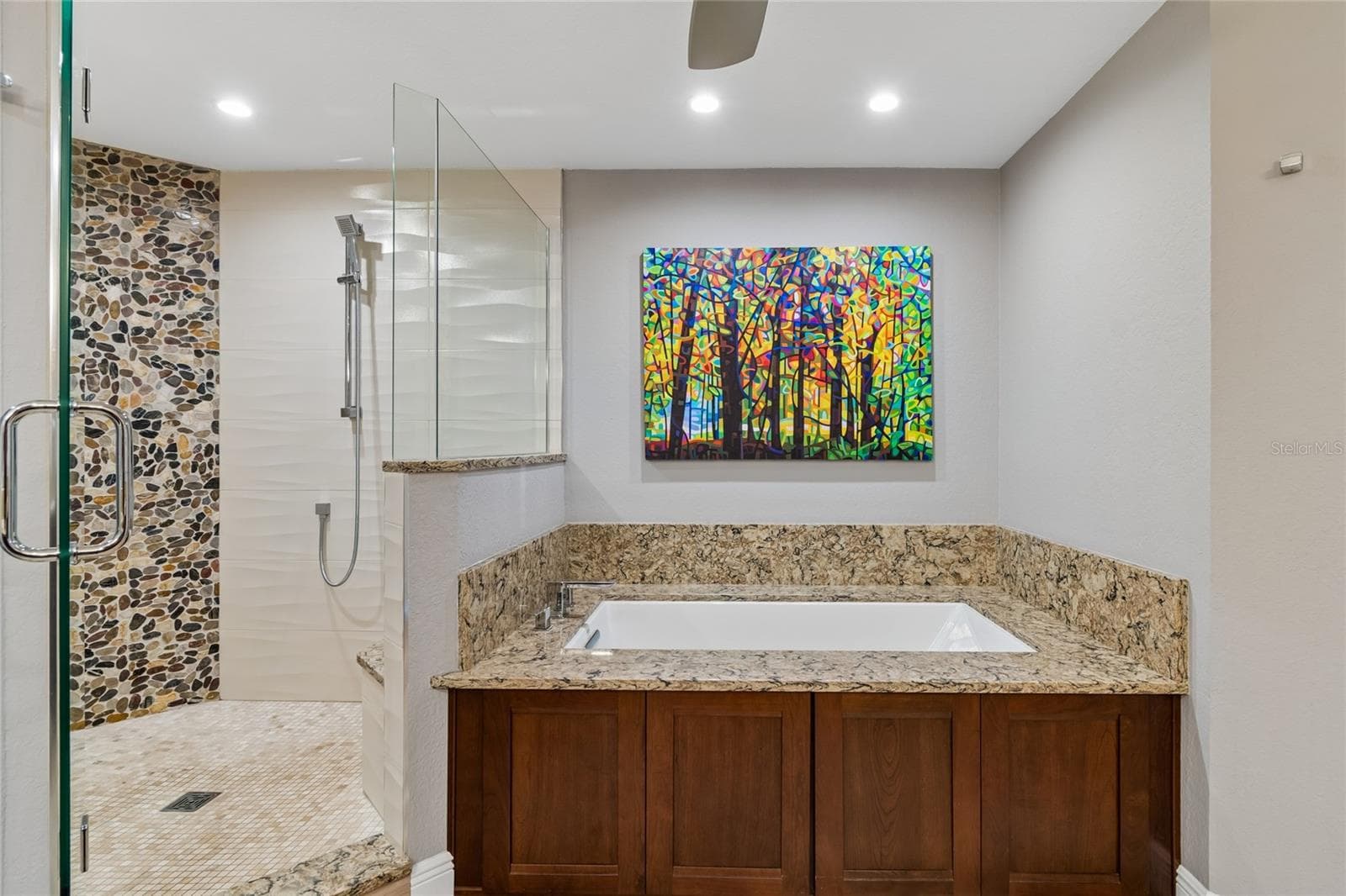 Modern en-suite primary bathroom with double sinks, large multiple head shower, and a water closet. - 152 117TH AVE, TREASURE ISLAND