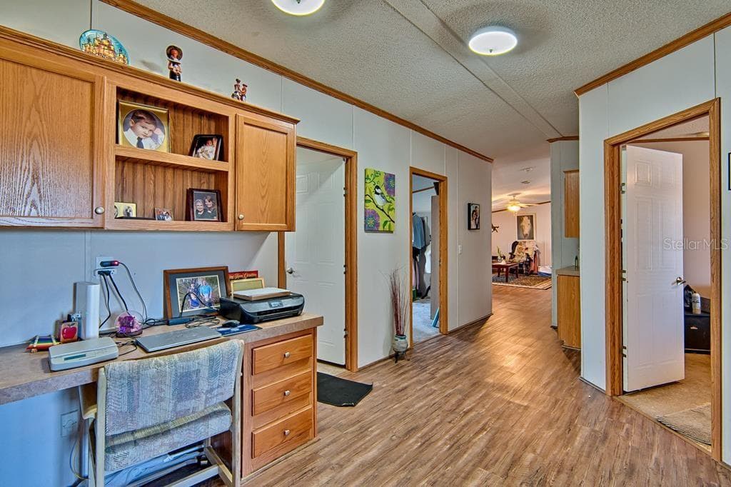 desk & storage cabinets built into hallway for office - 10250 NW 67TH PL, CHIEFLAND