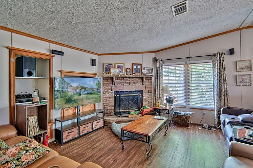 wood-burning fireplace in corner of family room - 10250 NW 67TH PL, CHIEFLAND