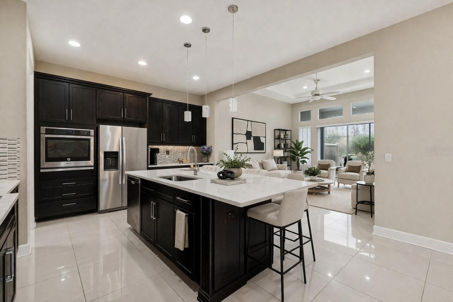 Virtually staged kitchen and living room - 4155 BARLETTA CT, WESLEY CHAPEL