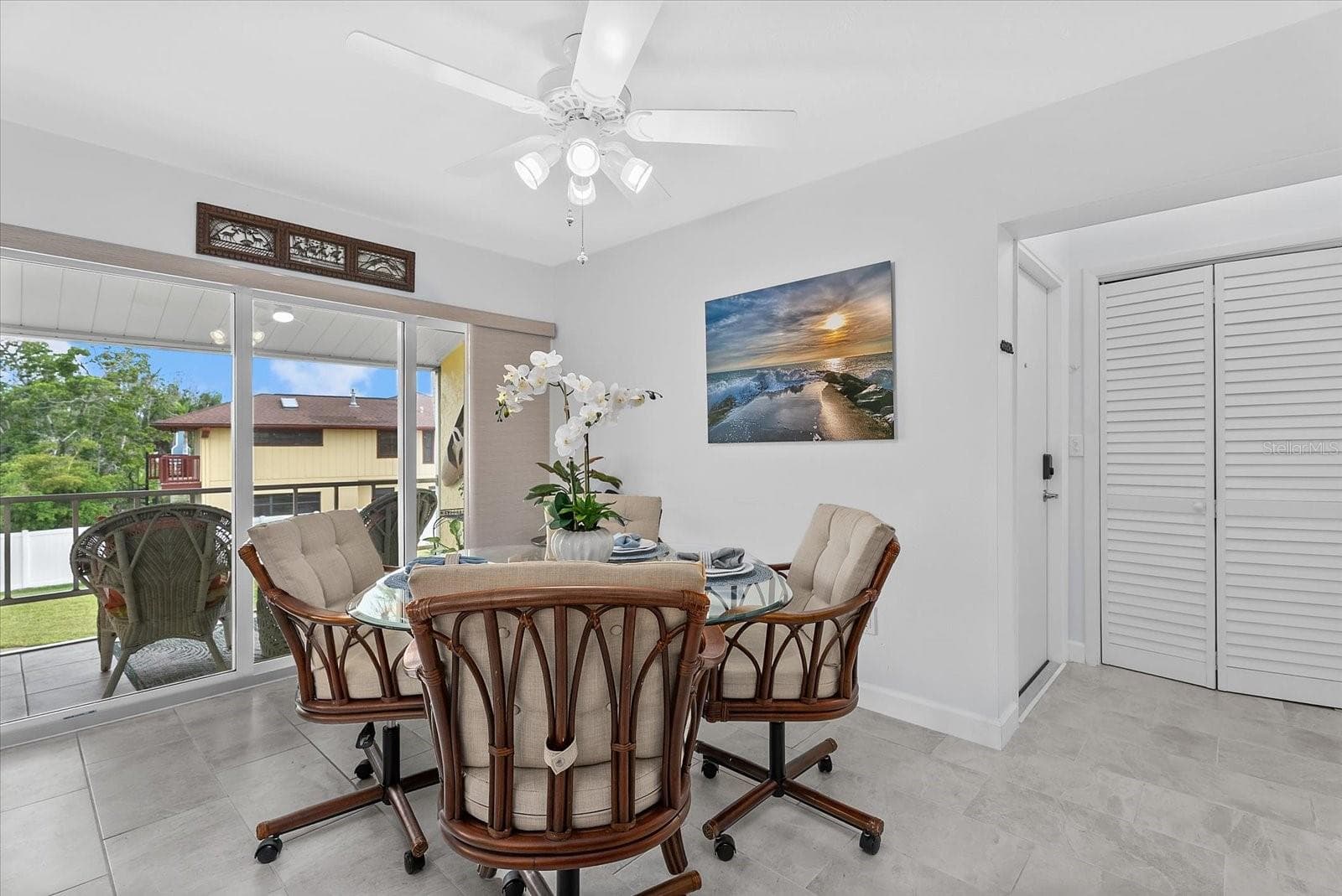 Dining room with a backdoor to the pool and kayak launch - 101 LOUELLA LN #10, NOKOMIS