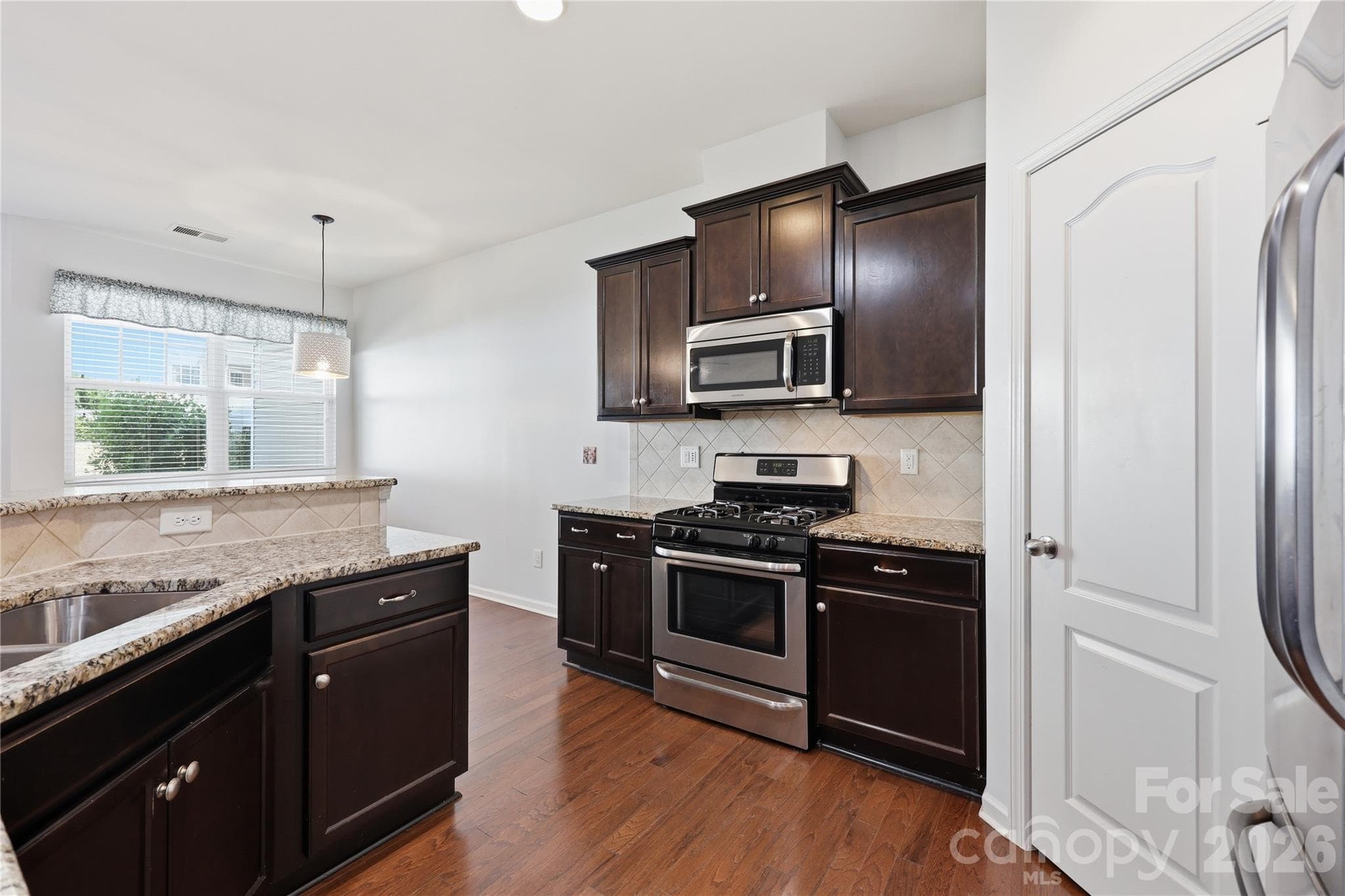Kitchen with Granite Counters & Stainless Steel Appliances - 7431 Calhoun Falls Drive, Rock Hill