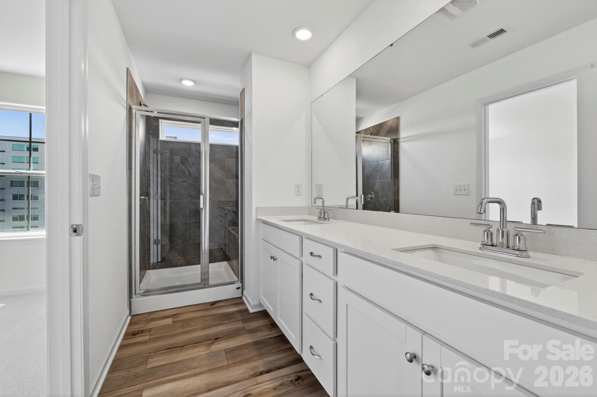 Owners elegant ensuite bath with tiled shower and bench seat - 107 Nablus Trail, Mooresville