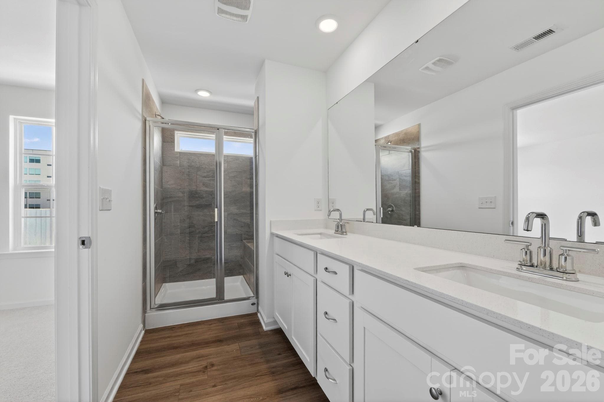 Owners spa like bathroom with tiled shower and bench seat - Mooresville